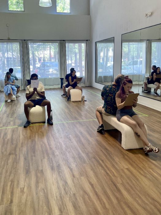 Students seated on the studio floor during a workshop exercise