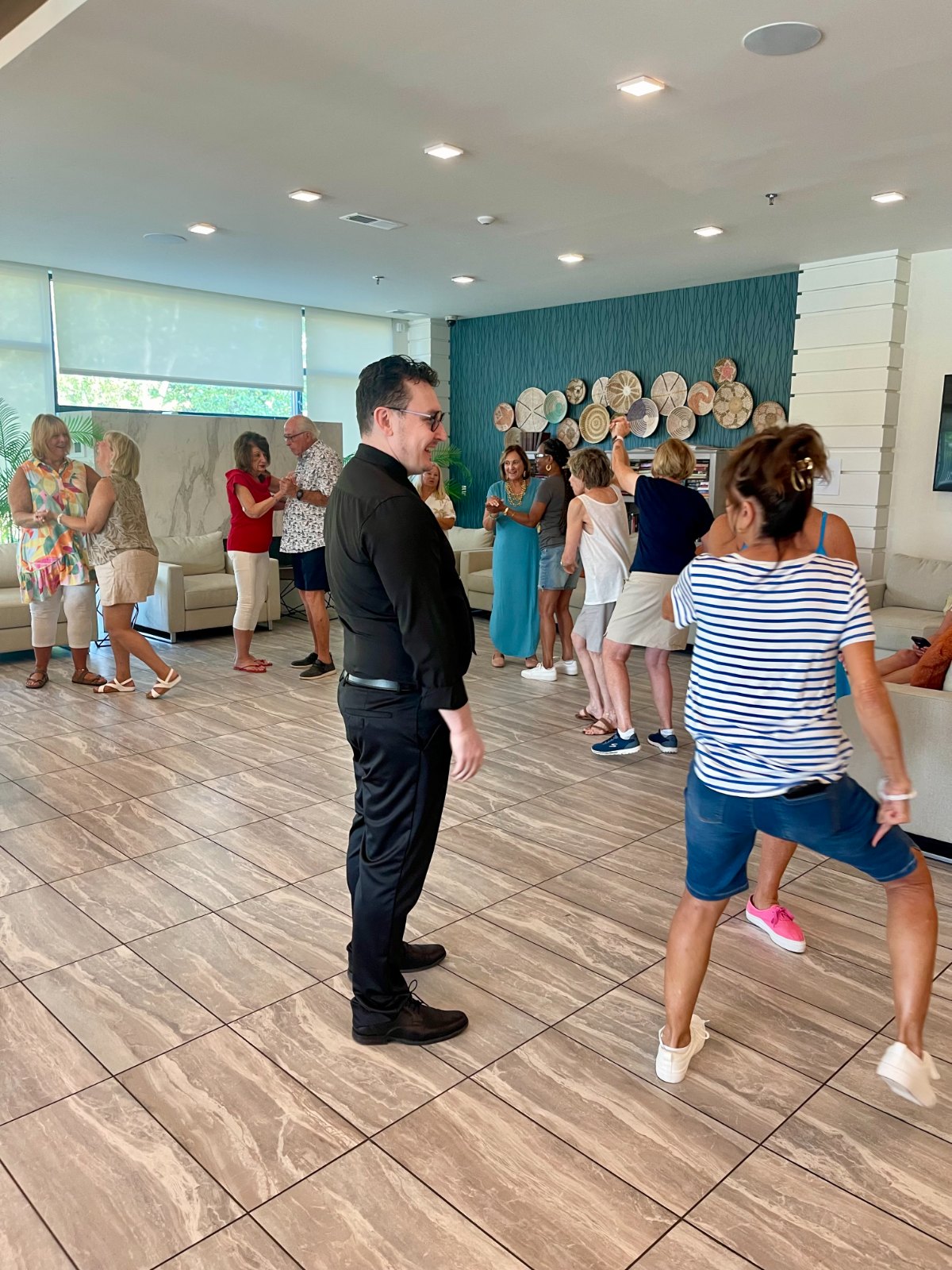An instructor leading a group class at a senior living community