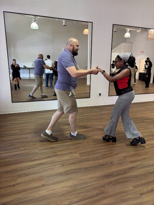 Partners working through a pattern at the mirrors